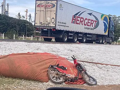 Ciclista é atingida por carga de algodão após carreta tombar em rotatória de Chapadão do Sul
